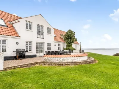 an exterior view of a house with a lawn at Holiday Home Thorge - 75m to the fjord by Interhome in Struer