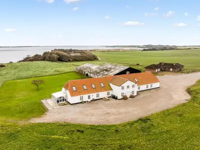 an aerial view of a large white house on a green field at Holiday Home Thorge - 75m to the fjord by Interhome in Struer
