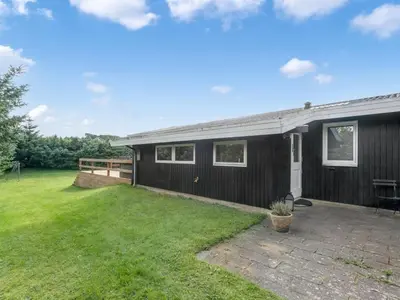 a home with a black house with a yard at Holiday Home Matilde - 400m to the fjord by Interhome in Struer
