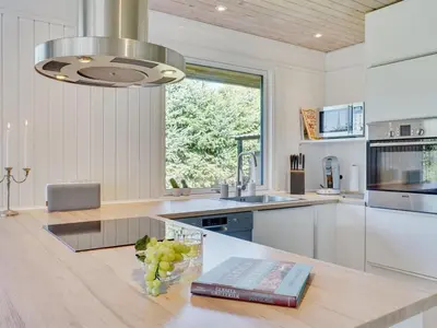a kitchen with a table with a book on it at Holiday Home Matilde - 400m to the fjord by Interhome in Struer