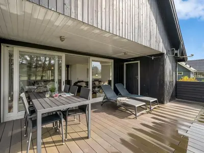 a patio with a table and chairs on a deck at Holiday Home Aleida - 100m to the fjord by Interhome in Vemb