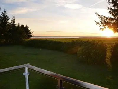 a sunset from the balcony of a house at Holiday Home Aleida - 100m to the fjord by Interhome in Vemb