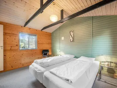 a bedroom with two beds in a room with wooden walls at Holiday Home Alpi - 250m to the fjord by Interhome in Struer