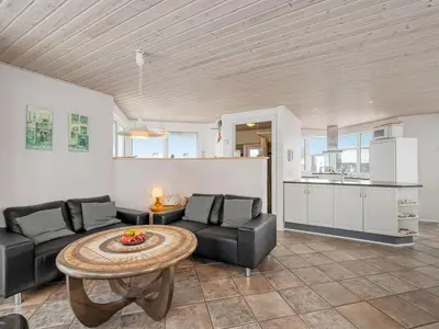 a living room with a couch and a table at Holiday Home Ginny - 300m to the fjord by Interhome in Struer