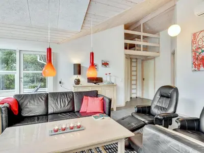 a living room with a black leather couch and chairs at Holiday Home Nani - 900m from the sea by Interhome in Torsted