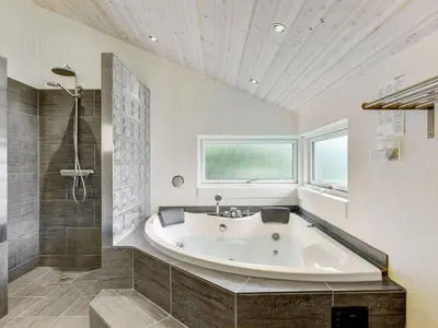 a large bathroom with a tub and a window at Holiday Home Nani - 900m from the sea by Interhome in Torsted