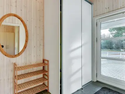 a room with a mirror and a wooden shelf at Holiday Home Nani - 900m from the sea by Interhome in Torsted