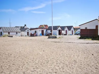 a row of houses on a beach with a dirt road at Holiday Home Nani - 900m from the sea by Interhome in Torsted