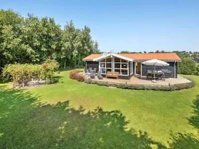 a house with a large yard with a patio at Holiday Home Kai - 500m to the fjord by Interhome in Struer