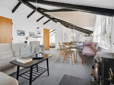 a living room with a couch and a table at Holiday Home Biriel - 1km from the sea by Interhome in Thisted