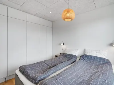 two beds in a room with white walls at Holiday Home Trpana - 1-6km from the sea by Interhome in Thisted