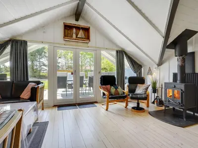 a living room filled with furniture and a fireplace at Holiday Home Hjalmara - 900m from the sea by Interhome in Thisted