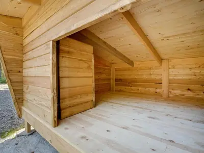 a wooden dog house with a door in the middle at Holiday Home Hjalmara - 900m from the sea by Interhome in Thisted