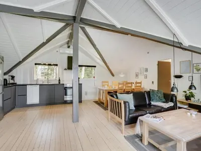 a living room with a couch and a table at Holiday Home Hjalmara - 900m from the sea by Interhome in Thisted