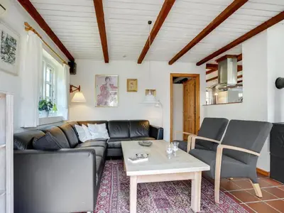 a living room with a couch and a table at Holiday Home Minja - 900m from the sea by Interhome in Thisted