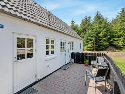 a white house with a patio and a fence at Holiday Home Minja - 900m from the sea by Interhome in Thisted
