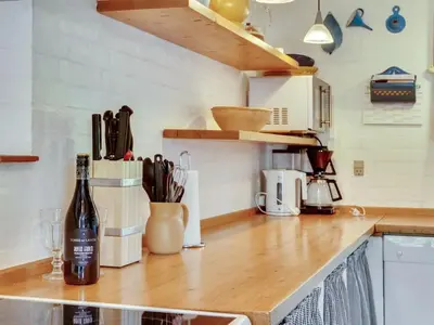 a kitchen with a bottle of wine on a counter at Holiday Home Minja - 900m from the sea by Interhome in Thisted