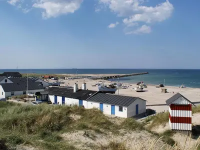 a view of a beach with buildings and the ocean at Holiday Home Engelbertine - 900m from the sea by Interhome in Thisted