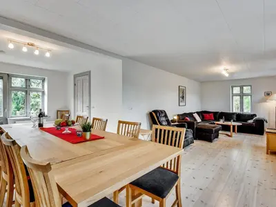 a dining room and living room with a table and chairs at Holiday Home Sophia - 8km from the sea by Interhome in Thisted