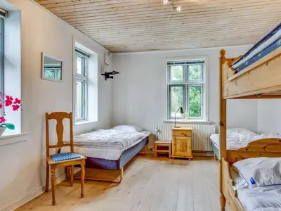 two beds in a room with two windows at Holiday Home Sophia - 8km from the sea by Interhome in Thisted