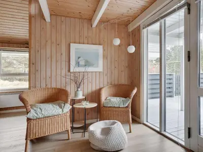 a living room with two chairs and a table at Holiday Home Bente - 800m from the sea by Interhome in Thisted
