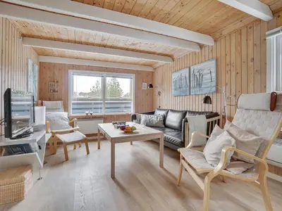 a living room with a couch and a table at Holiday Home Bente - 800m from the sea by Interhome in Thisted