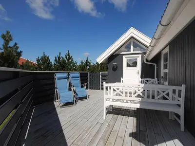 a deck with two chairs and a house at Holiday Home Bente - 800m from the sea by Interhome in Thisted