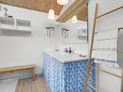 a kitchen with a sink and a bench in a room at Holiday Home Ljupka - 1km from the sea by Interhome in Thisted
