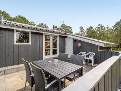 a patio with a table and chairs on a deck at Holiday Home Ljupka - 1km from the sea by Interhome in Thisted