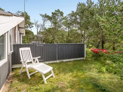 a yard with a chair and a fence at Holiday Home Ljupka - 1km from the sea by Interhome in Thisted
