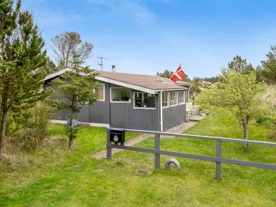 a house with a flag on top of it at Holiday Home Gundina - 2km from the sea by Interhome in Thisted