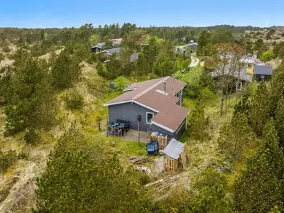 an overhead view of a house on a hill with trees at Holiday Home Gundina - 2km from the sea by Interhome in Thisted