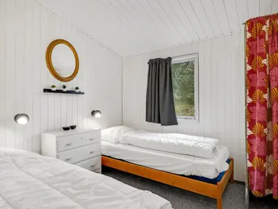 a bedroom with two beds and a mirror and a window at Holiday Home Gundina - 2km from the sea by Interhome in Thisted