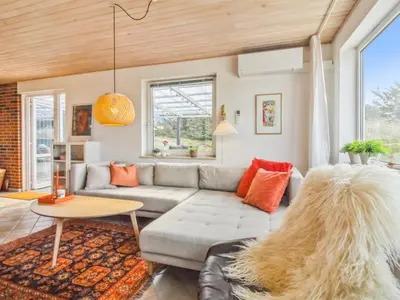 a living room with a couch and a table at Holiday Home Madsen - 500m from the sea by Interhome in Thisted