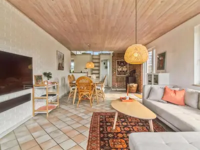 a living room with a couch and a table at Holiday Home Madsen - 500m from the sea by Interhome in Thisted