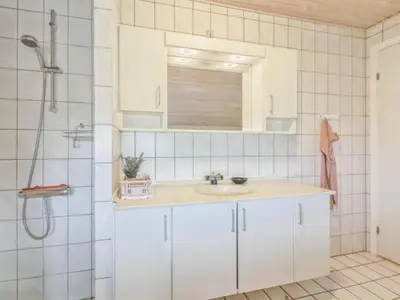 a bathroom with a sink and a shower at Holiday Home Madsen - 500m from the sea by Interhome in Thisted