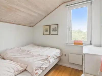a bedroom with a bed and a window at Holiday Home Madsen - 500m from the sea by Interhome in Thisted