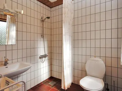 a bathroom with a toilet and a sink at Holiday Home Neven - 900m from the sea by Interhome in Torsted