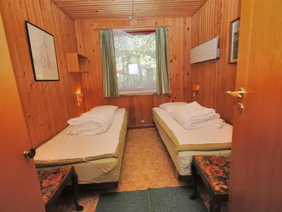 a small room with two beds and a window at Holiday Home Neven - 900m from the sea by Interhome in Torsted