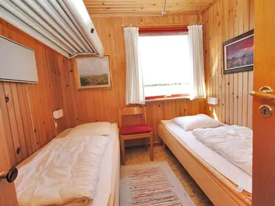 a bedroom with two beds and a window at Holiday Home Neven - 900m from the sea by Interhome in Torsted