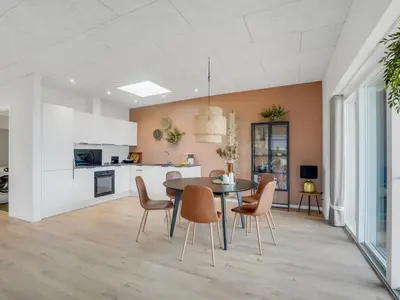 a kitchen and dining room with a table and chairs at Holiday Home Kasper - 1-8km from the sea by Interhome in Thisted