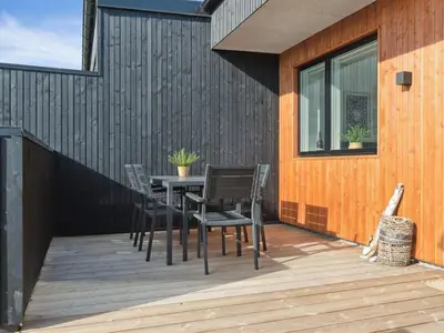 a patio with a table and chairs on a building at Holiday Home Kasper - 1-8km from the sea by Interhome in Thisted