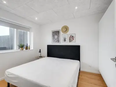 a bedroom with a white bed and a window at Holiday Home Kasper - 1-8km from the sea by Interhome in Thisted