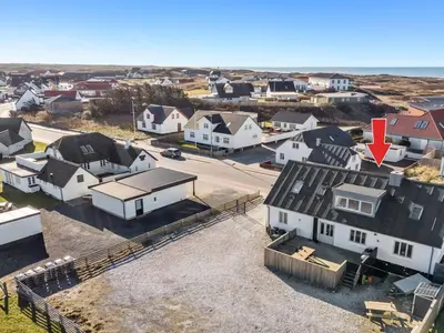 an aerial view of a town with houses and a red arrow at Holiday Home Thilla - 100m from the sea by Interhome in Thisted