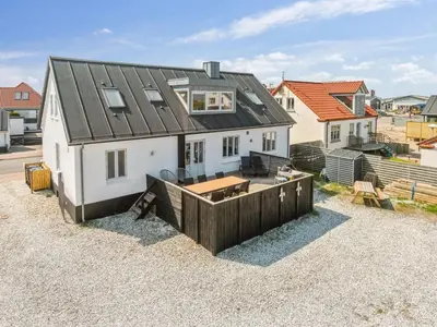 a white house with a black roof at Holiday Home Thilla - 100m from the sea by Interhome in Thisted