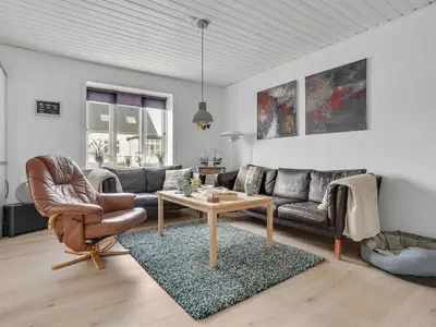 a living room with a couch and a table at Holiday Home Thilla - 100m from the sea by Interhome in Thisted