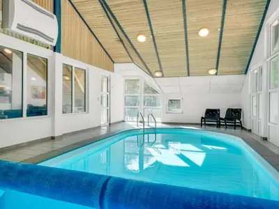 a swimming pool in a house with a ceiling at Holiday Home Eisa - 300m to the fjord by Interhome in Øsløs