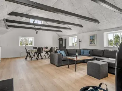 a living room with a couch and a table at Holiday Home Elisa - 1-2km from the sea by Interhome in Bedsted Thy