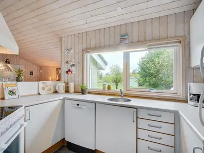 a kitchen with a sink and a window at Holiday Home Aameek - 3km from the sea by Interhome in Frøstrup
