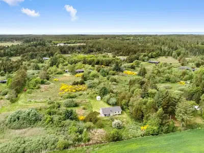 an aerial view of a farm with a house and trees at Holiday Home Aameek - 3km from the sea by Interhome in Frøstrup